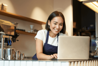 Cafe worker on laptop