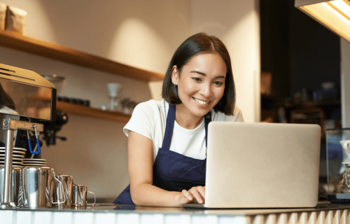 Cafe worker on laptop