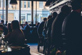 euan cameron busy restaurant dark seated diners