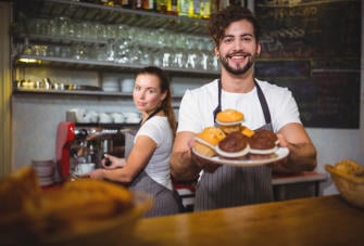 portrait waiter holding plate cup cake counter 1