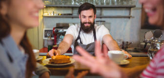 waiter serving cup coffee sweet food customers