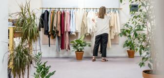 woman fixing clothes on the rack 3965548
