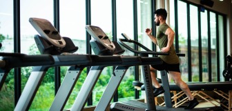 Man running on gym treadmill
